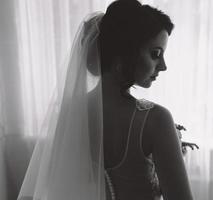 Bride posing in a large window photo