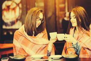 Two young and beautiful girls gossiping photo