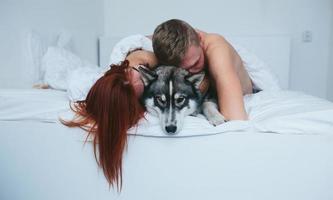 Young adult couple lying on bed photo