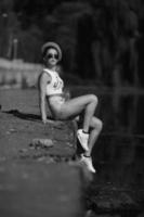 beautiful girl sitting on the pier photo