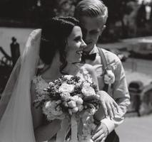 bride and groom posing on the streets photo