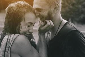 beautiful couple hugging in the rain photo