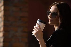 Beautiful girl in glasses with coffee photo