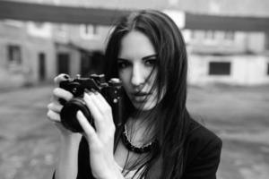 Beautiful female photographer posing with camera photo