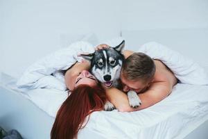 Young adult couple lying on bed photo