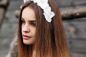 Lovely girl near a wooden house photo