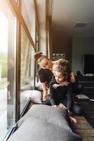 Mom and two daughters together at the window photo