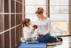 Mother and daughter playing with toys in the gym photo