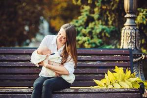 mother and two daughters rest on a bench photo