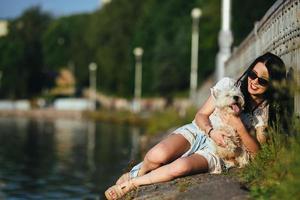 girl with a dog on the lake photo