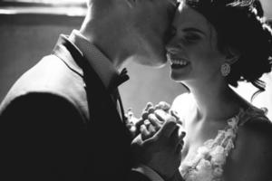 bride and groom on the background of a window. photo