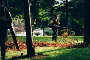 People operating a heavy duty leaf blower. photo