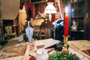 Candlesticks with red candle on the table photo