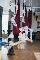 Young girls do aerial yoga in the gym photo