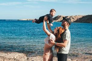 Parents playing with their little son photo