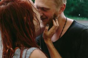 beautiful couple kissing  in the rain photo