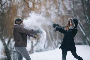 man and woman throwing snowballs photo