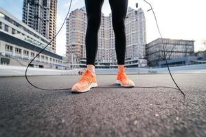 Young woman exercise with skipping rope outdoors photo