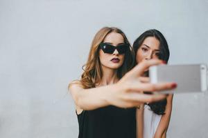 Two girlfriends taking a selfie photo