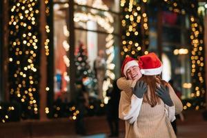 Portrait of happy cute young friends hugging each other photo