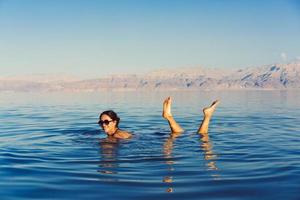 Girl is relaxing and swimming in the water photo