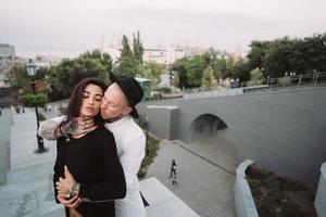 A young, sexy couple of lovers pose for a camera on the streets photo