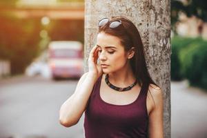 pretty girl sitting in a city street photo