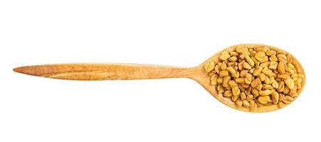 top view of wood spoon with fenugreek seeds photo