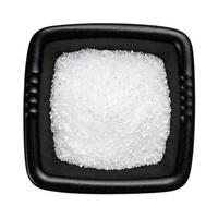 crystalline citric acid in black bowl isolated photo