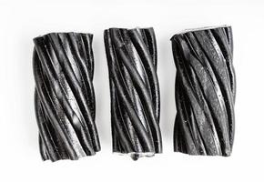 few coiled black licorice candies on white photo