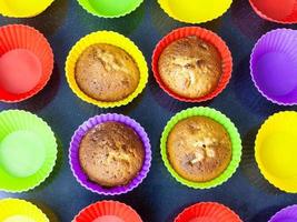 top view of four cupcakes in multicolored molds photo