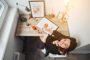 Young woman painting with watercolor paints photo