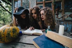 Three vintage witches perform magic ritual photo