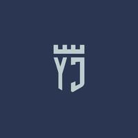 monograma del logotipo de yj con castillo de fortaleza y diseño de estilo de escudo vector