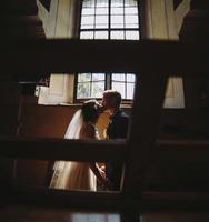 bride and groom on the background of a window. photo