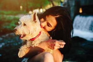 girl playing with a dog photo