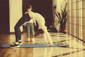 Two girls of different ages makeing yoga photo