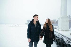 couple posing in a snowy park photo