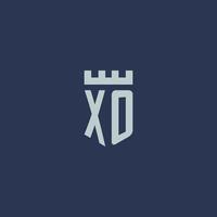 monograma del logotipo xo con castillo de fortaleza y diseño de estilo escudo vector