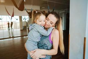 Mother holds her daughter in her arms photo