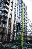 Young woman having fun on the rope pyramid photo