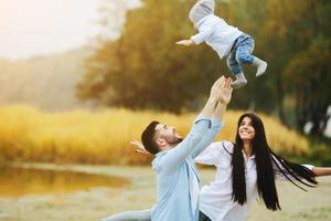 Dad throws up his young son photo