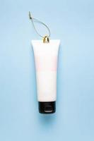 Mockup facial skincare white tube bottle on blue background, Cosmetics decoration for festive season. Concept photo