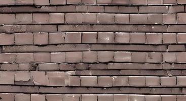 Brown brick wall. Texture of old dark brown and red brick wall panoramic backgorund. photo