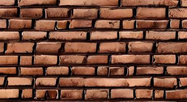 A wall of old, cracked bricks, with a weathered and faded surface. Restored brickwork of an old house. photo