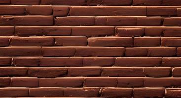 Dark brown old bricks wall panorama photo