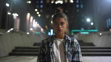 Girl looks and talk to camera in the city at night video