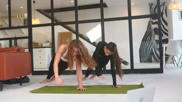 Girls doing online yoga at living room video