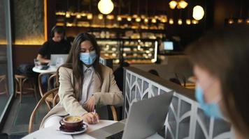 Three women having a meeting at coffee shop video