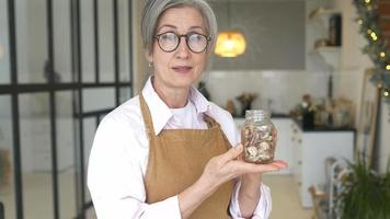 Woman proudly shows dry ingredients in jars video